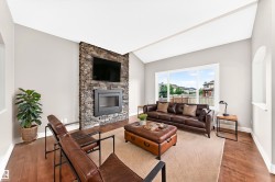 Vaulted ceiling with a stone-clad fireplace and large windows - 