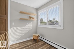 Wood-finish flooring, built-in wooden cabinetry, and two floating wooden shelves - 
