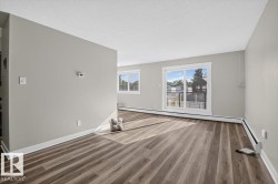 Wood-finish flooring throughout, light gray wall paint, and white trim - 