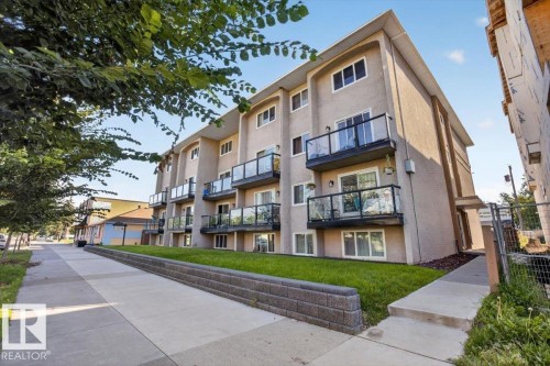 Stucco exterior with multiple private balconies, each featuring glass and metal railings - #205 11429 124 St Nw, Edmonton, AB - Outdoor