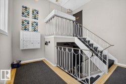 Multilevel staircase with white decorative railing, carpeted treads, and wood-finish flooring - 