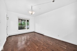 Hardwood flooring throughout, large window with white blinds, and a semi-flush mount ceiling fixture - 