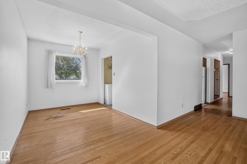 Hardwood flooring, white walls, window, chandelier, recessed lighting - 16009 93A Avenue Nw, Edmonton, AB - Indoor Photo Showing Other Room