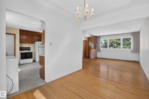 Hardwood flooring, chandelier lighting, and a large window with natural light - 16009 93A Avenue Nw, Edmonton, AB - Indoor Photo Showing Kitchen