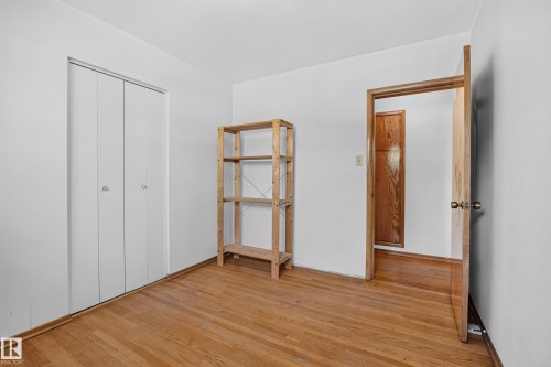 Hardwood flooring, white walls, and a wood-finish door frame - 16009 93A Avenue Nw, Edmonton, AB - Indoor