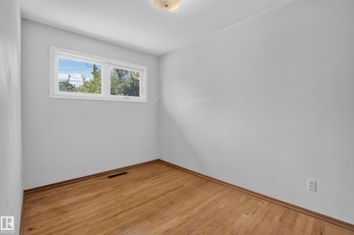 Hardwood flooring, white walls, and a window providing natural illumination - 16009 93A Avenue Nw, Edmonton, AB - Indoor Photo Showing Other Room