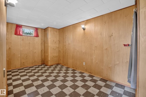 Paneling-clad walls, checkered flooring, and a drop ceiling - 16009 93A Avenue Nw, Edmonton, AB - Indoor
