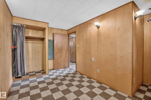 Wood paneling throughout, checkered flooring, open shelving, and built-in wall sconces - 16009 93A Avenue Nw, Edmonton, AB - Indoor Photo Showing Other Room