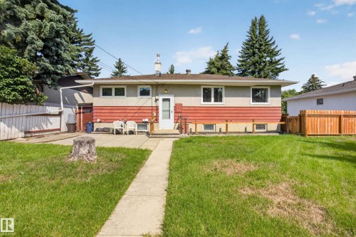 Expansive backyard featuring a concrete pathway, patio area, and mature trees - 16009 93A Avenue Nw, Edmonton, AB - Outdoor