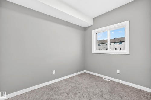 Carpeted flooring, gray wall paint, white trim, and a double-pane window - 426 Crystal Creek Link, Leduc, AB - Indoor Photo Showing Other Room