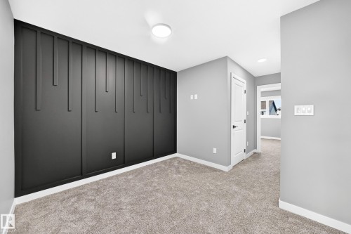 Accent wall with decorative paneling - 426 Crystal Creek Link, Leduc, AB - Indoor Photo Showing Other Room