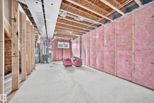 Unfinished basement with exposed ceiling joists, concrete flooring, insulated perimeter walls, and framed interior walls - 426 Crystal Creek Link, Leduc, AB - Indoor Photo Showing Basement