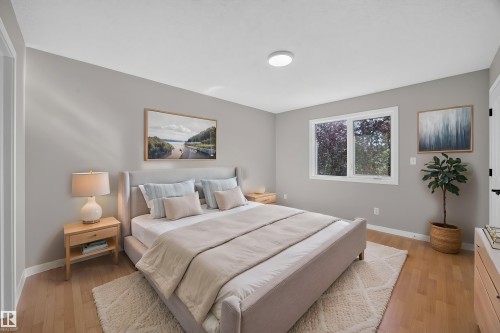 Recessed ceiling light, light-toned wood-finish flooring, and a white framed window - 3640 31 Street Nw, Edmonton, AB - Indoor Photo Showing Bedroom