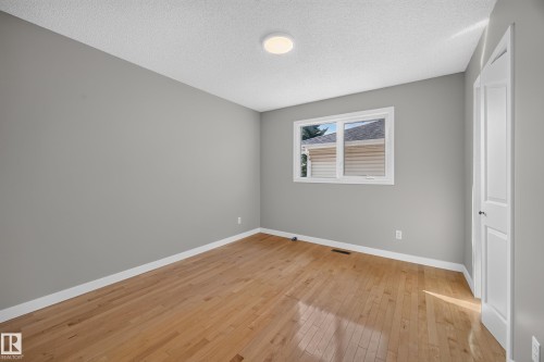 Bedroom 2.  Hardwood flooring, painted walls, white trim, single window, and a flush mount ceiling light - 3640 31 Street Nw, Edmonton, AB - Indoor Photo Showing Other Room