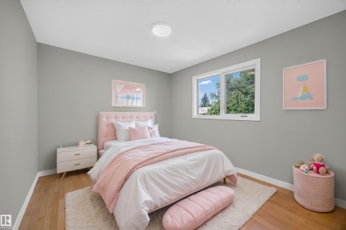 Hardwood flooring, light gray wall finishes, recessed ceiling lighting, and a large window - 3640 31 Street Nw, Edmonton, AB - Indoor Photo Showing Bedroom