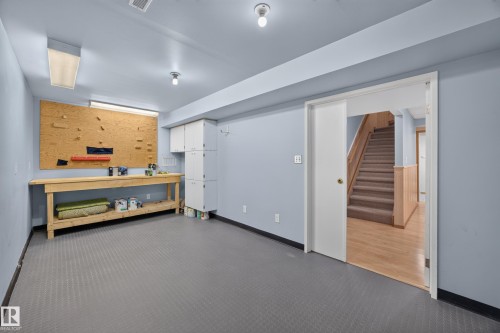 Spacious room with gray textured flooring and light blue walls - 3640 31 Street Nw, Edmonton, AB - Indoor Photo Showing Other Room