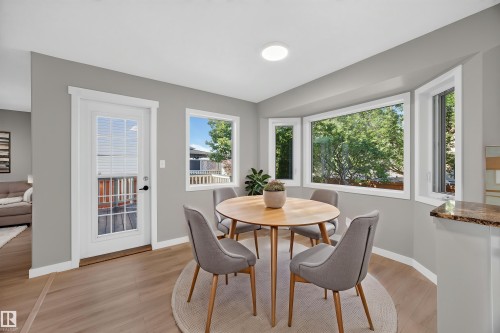 Wood-finish flooring, white trim, recessed lighting, and a bay window - 3640 31 Street Nw, Edmonton, AB - Indoor Photo Showing Dining Room