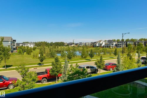 Expansive green space and water feature with surrounding residential structures - 8265 Chappelle Way Sw, Edmonton, AB - Outdoor With View