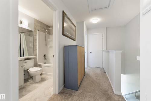 Bathroom with a full bathtub, tiled shower surround, and a vanity with an integrated sink - 8265 Chappelle Way Sw, Edmonton, AB - Indoor Photo Showing Bathroom