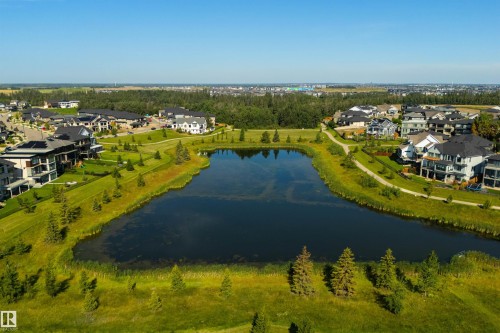 Waterfront property with established landscaping and paved pathways - 8265 Chappelle Way Sw, Edmonton, AB - Outdoor With Body Of Water With View