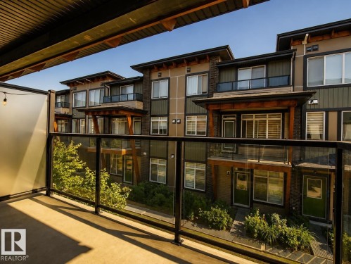 Concrete balcony with glass railing and privacy screening - #53 16231 19 Av Sw, Edmonton, AB - Outdoor With Balcony