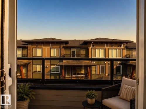 Balcony with glass railing and composite decking - #53 16231 19 Av Sw, Edmonton, AB - Outdoor With Balcony