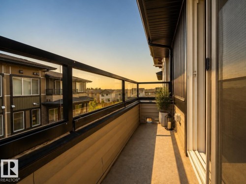 Balcony with glass panel railing and concrete flooring - #53 16231 19 Av Sw, Edmonton, AB -  With Balcony With Exterior
