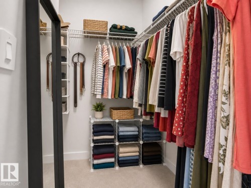 Wall-mounted wire shelving with hanging rods - #53 16231 19 Av Sw, Edmonton, AB - Indoor With Storage