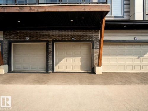 Brick facade with three panel garage doors - #53 16231 19 Av Sw, Edmonton, AB - Outdoor With Balcony With Exterior