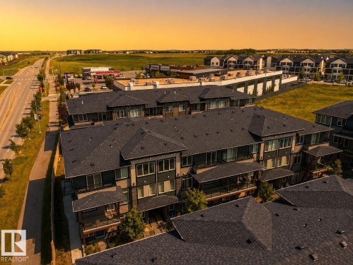 Modern multi-unit property featuring dark shingle roofs, private balconies, and landscaped grounds - #53 16231 19 Av Sw, Edmonton, AB - Outdoor With View