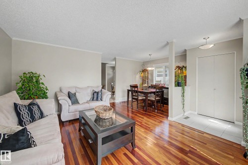 Wood-finish flooring throughout the living area - 193 Kiniski Crescent Nw, Edmonton, AB - Indoor Photo Showing Living Room