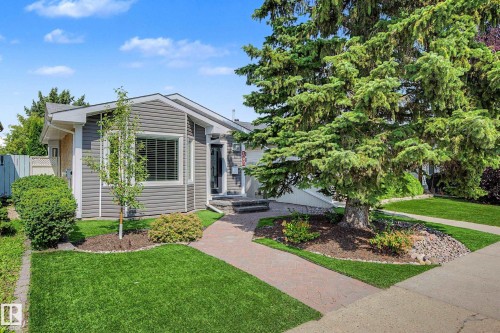 Exterior featuring gray horizontal siding, a gabled roofline, a concrete walkway, and established landscaping - 193 Kiniski Crescent Nw, Edmonton, AB - Outdoor