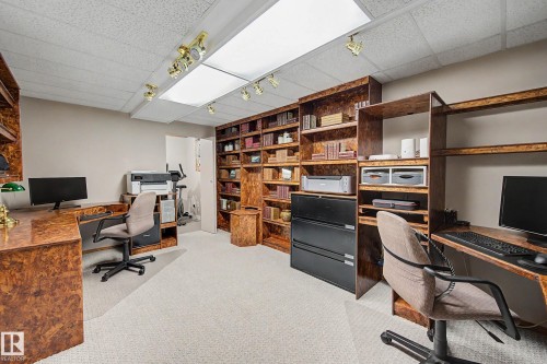 Carpeted flooring with built-in wood-finish shelving and desks - 193 Kiniski Crescent Nw, Edmonton, AB - Indoor Photo Showing Office