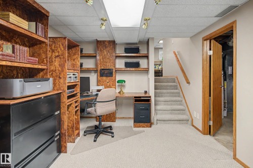 Built-in wood-finish shelving, desk space, recessed ceiling lighting, and a carpeted staircase - 193 Kiniski Crescent Nw, Edmonton, AB - Indoor