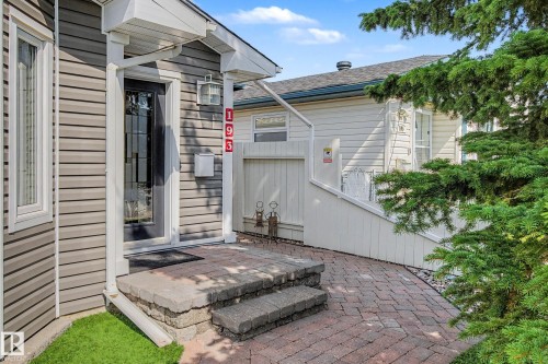 Siding exterior with a covered entry, paver stone walkway, and stone block steps - 193 Kiniski Crescent Nw, Edmonton, AB - Outdoor