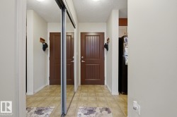 Mirrored sliding closet doors, ceiling-mounted light fixture, and tile flooring - 