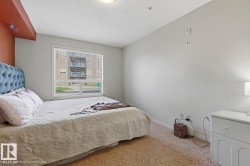 Hardwood-finish flooring, white walls, and a large window with white trim - 
