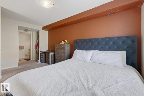 Carpeted flooring, recessed ceiling fixture, and a built-in wall niche - #106 13907 136 St Nw, Edmonton, AB - Indoor Photo Showing Bedroom