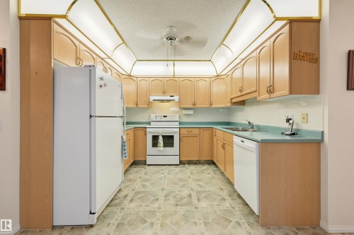 #211 10915 21 Av Nw, Edmonton, AB - Indoor Photo Showing Kitchen With Double Sink