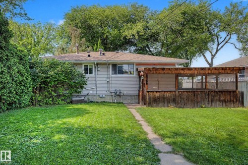 Expansive backyard with a covered wooden deck structure - 9723 76 Street Nw, Edmonton, AB - Outdoor