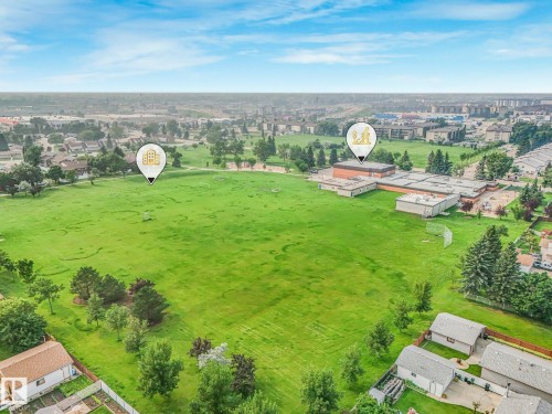 Expansive green space featuring a large field and mature trees - 4135 134 Avenue Nw, Edmonton, AB - Outdoor With View