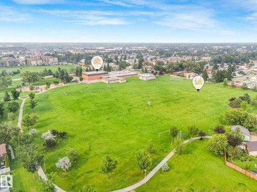 Expansive green space featuring curved paved paths, mature trees, and sports fields - 4135 134 Avenue Nw, Edmonton, AB - Outdoor With View