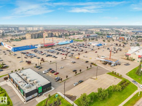Expansive commercial property featuring a large parking area, multiple retail buildings, and a fueling station - 4135 134 Avenue Nw, Edmonton, AB - Outdoor With View