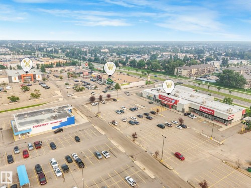 Aerial perspective of a commercial area featuring multiple retail establishments and extensive parking facilities - 4135 134 Avenue Nw, Edmonton, AB - Outdoor With View