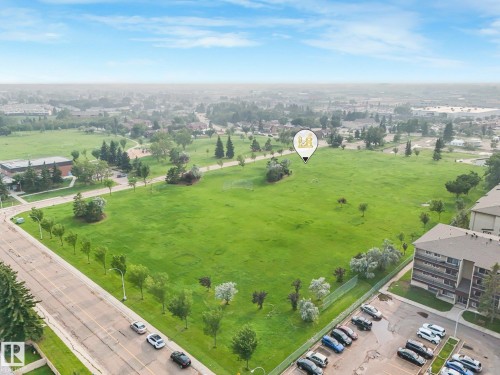 Expansive green space featuring mature trees and established pathways - 4135 134 Avenue Nw, Edmonton, AB - Outdoor With View