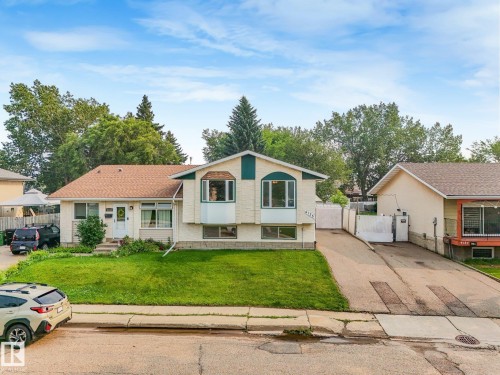 Cream-colored exterior with a contrasting green accent - 4135 134 Avenue Nw, Edmonton, AB - Outdoor With Facade