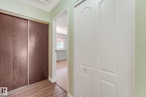 Hallway featuring wood-finish flooring and light green walls - 4135 134 Avenue Nw, Edmonton, AB - Indoor Photo Showing Other Room