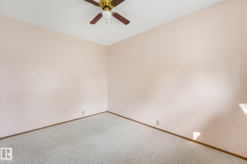 Expansive room featuring light-toned walls and a textured carpet - 4135 134 Avenue Nw, Edmonton, AB - Indoor Photo Showing Other Room