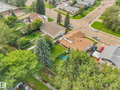 Aerial view showcasing a residential property with a brown-shingled roof, a spacious green lawn, and mature trees - 4135 134 Avenue Nw, Edmonton, AB - Outdoor With View
