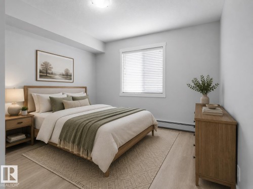 Recessed ceiling lighting, wood-finish flooring, and a large window with white blinds - #205 5816 Mullen Pl Nw, Edmonton, AB - Indoor Photo Showing Bedroom